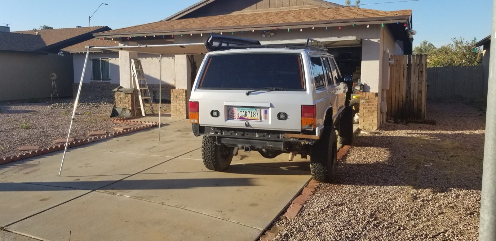 Jeep Cherokee with its rear camp canopy opened