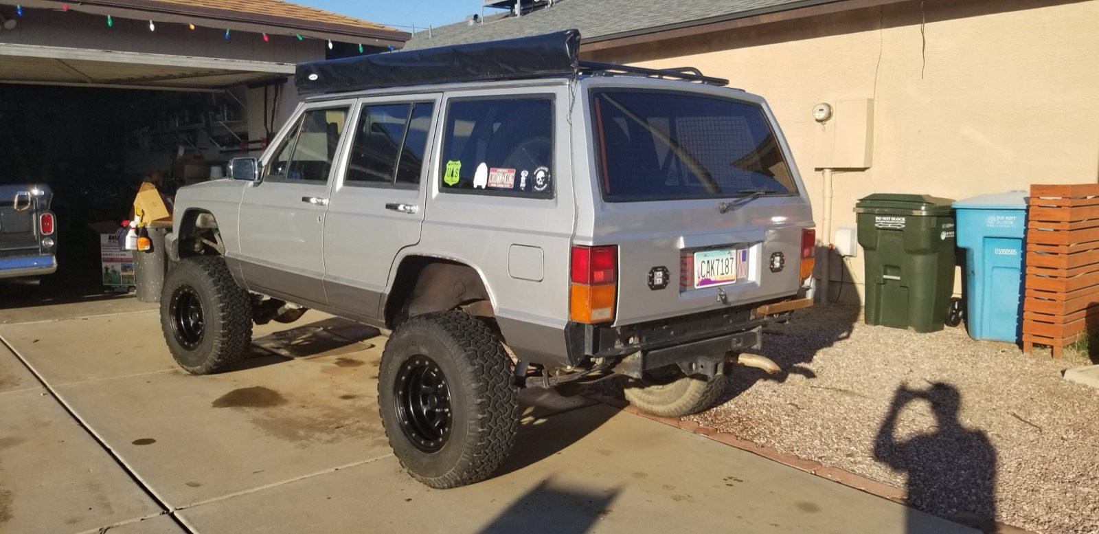 Lifted Jeep Cherokee in the driveway from the rear quarter